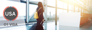 Professional traveler at an airport, representing travel under an O1 visa.